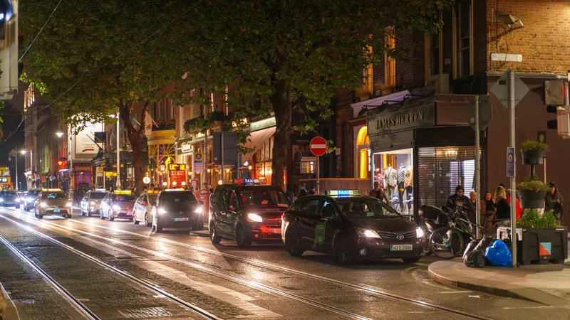 Dawson Street in Dublin on an autumn evening with taxis and lit shopfronts